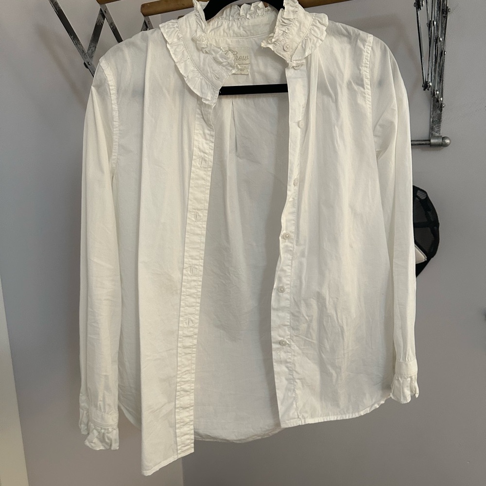 Crisp white cotton shirt. Ruffle at colar and sleeve. Gently worn.